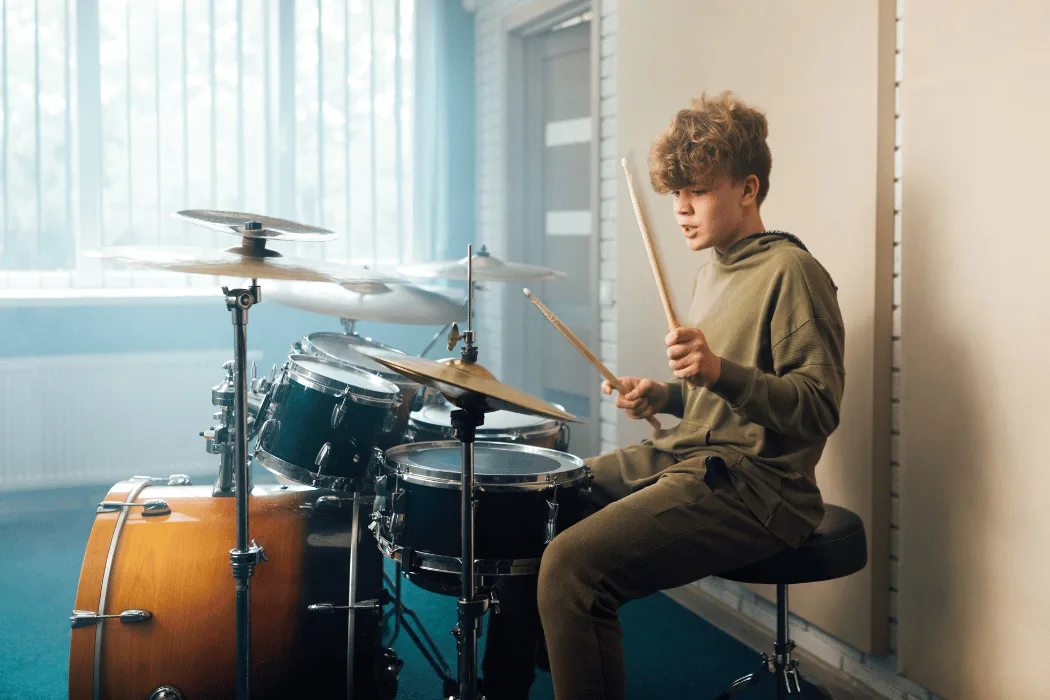 Child practicing basic drum rhythms in a London