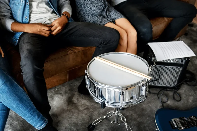 Adult beginner learning drums during a London music lesson
