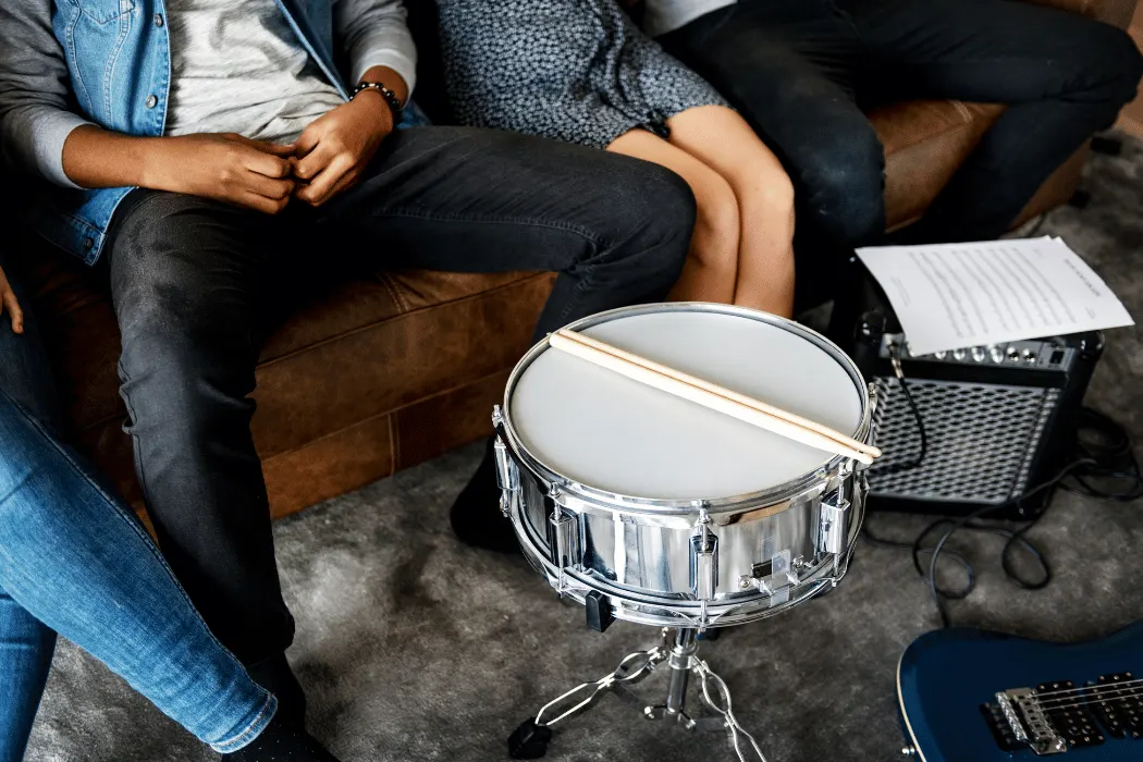 Adult beginner learning drums during a London music lesson